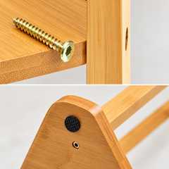 Close-up of a hex screw on a bamboo shelf edge and a black floor pad on the triangular base of the coat rack