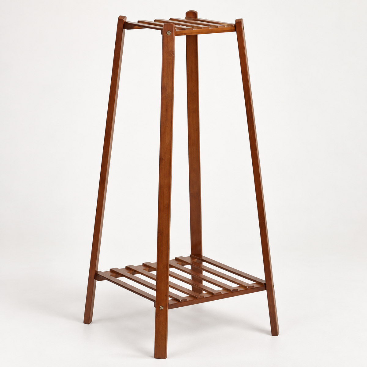 Empty brown bamboo plant stand in angled view showing slatted top and bottom shelves and screw joints