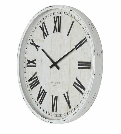 Antique white wall clock styled in a room