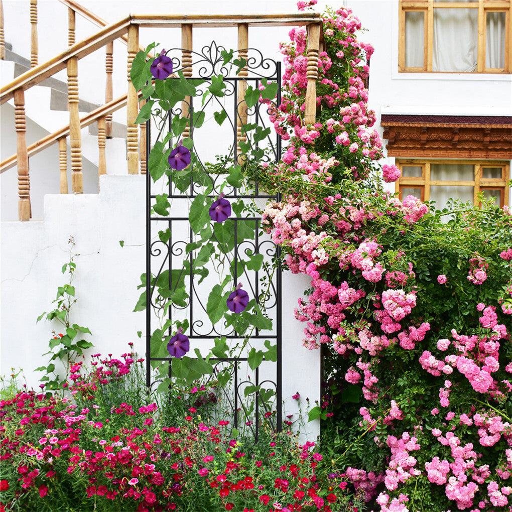 Tall garden trellis installed beside a flower bed