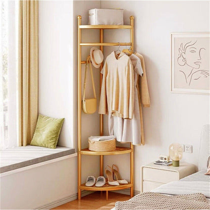 Slim gold coat stand styled in a bedroom corner
