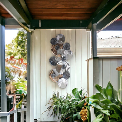 Textured metal wall décor in black, white and gold tones