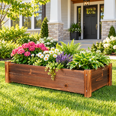 Wooden garden planter box with pink hydrangeas, daisies, lavender and hostas on a lawn in front of a house